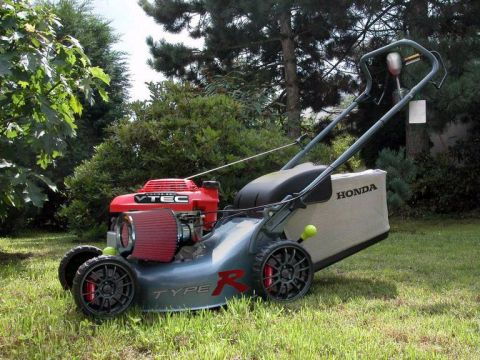 1994 Ford Probe - A Honda lawnmower with a VTEC engine and custom wheels sits on a grassy lawn.