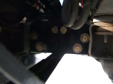 1990 Chevrolet Suburban - Detail of vehicle frame and fasteners, showing a section of suspension spring.