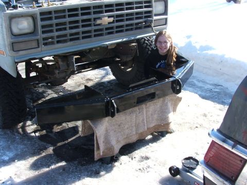 1990 Chevrolet Suburban - A person poses with a new aftermarket bumper installed on a vintage Chevrolet truck.