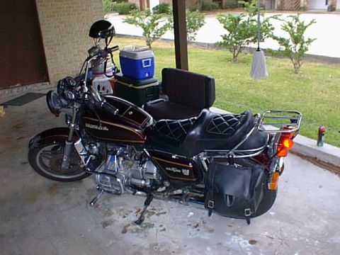 1981 Honda GL11GoldWing - A 1981 Honda GL1100 Gold Wing motorcycle is parked in a garage with a cooler and helmet nearby.