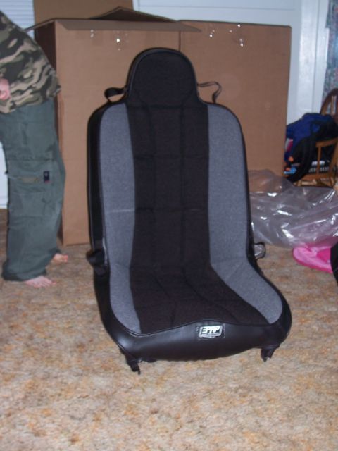 1988 Suzuki Samurai - A single aftermarket car seat is shown indoors, with a person and boxes in the background.
