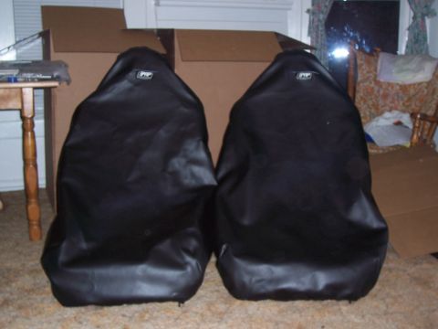 1988 Suzuki Samurai - Two black car seat covers are shown indoors, likely for storage or sale.