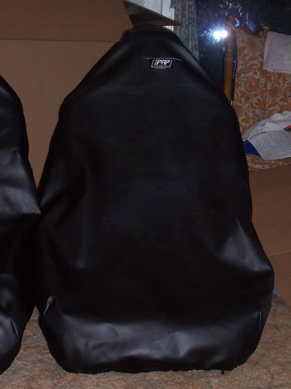 Black PRP seat covers with a visible logo, covering car seats
