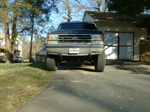 1991 Ford Bronco - This 1991 Ford Bronco is shown from the front, a lifted suspension and a dark-colored body.