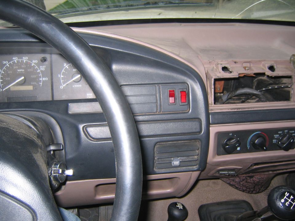 Heres my hack job of installing the switches for my interior lights and my undercarriage crawling lights, oh yea notice my super high tech invisible cd/mp3 player, stolen right out front of my apartment a few months ago, oh also if ya look down under the AC controls you can see where the fire i had came into the cab and melted part of the dash, it was just after putting the body lift on and the shifter covers were still off.
