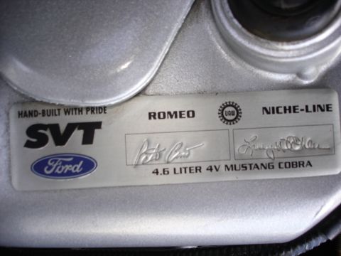 1998 Ford Taurus - Close-up of an engine plaque indicating a 4.6 Liter 4V Mustang Cobra, hand-built with pride in Romeo.