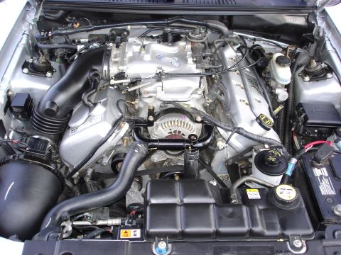 1998 Ford Taurus - Engine bay of a Ford Mustang, showing the V8 engine components and associated hardware.