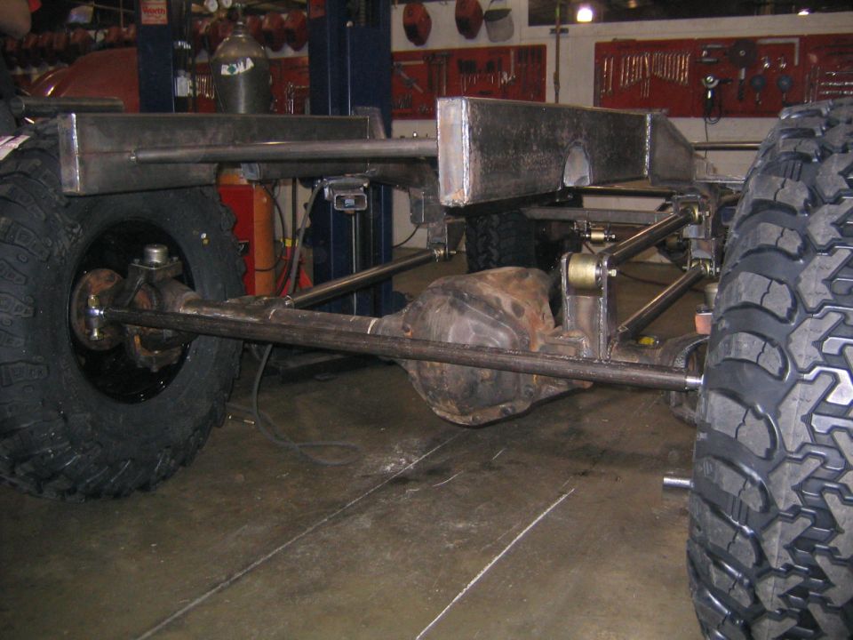 Custom off-road chassis with large tires and suspension components visible