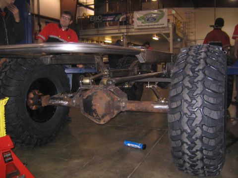 1978 Ford Bronco - The underside of a custom-built off-road vehicle shows its heavy-duty suspension and large tires.