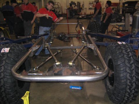 1978 Ford Bronco - The chassis of a vehicle is shown with its suspension and large tires, indicating it is undergoing modifications or assembly.