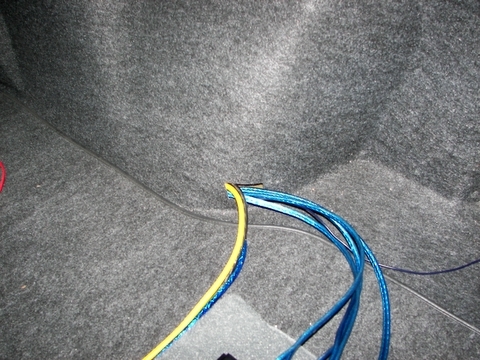 2000 Ford Taurus - Audio System Installation - RCA and Speaker wires fed through opening in right rear wheel well cover