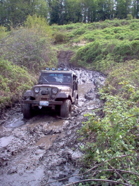 2001 Ford Taurus - This Jeep CJ-5 navigates a challenging muddy terrain, its off-road capabilities.