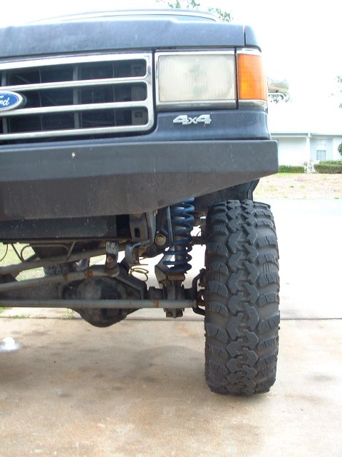 1995 Ford Bronco - Front view of a 1995 Ford Bronco, highlighting the wheel, suspension, and 4x4 badging.