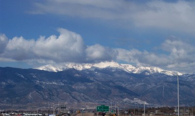 1972 Ford Ranchero - A scenic view of snow-covered mountains above a highway under a partly cloudy sky.