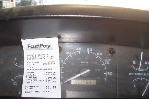 1994 Ford F-150 - Dashboard interior with a gas receipt and odometer reading 156976.3.
