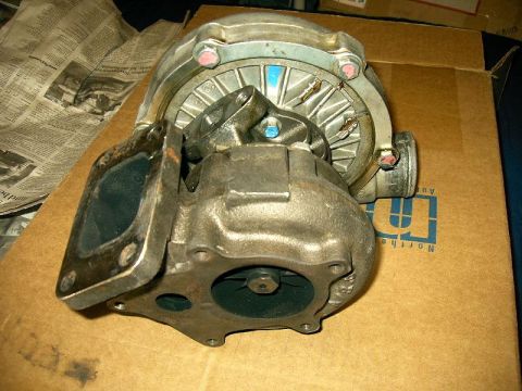 1992 Ford Probe - Turbocharger part shown on a cardboard box with newspaper in the background.