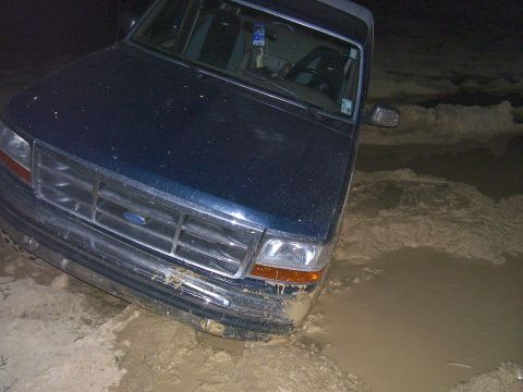1992 Ford Bronco - This 1992 Ford Bronco is stuck in a muddy area, with its front end submerged.