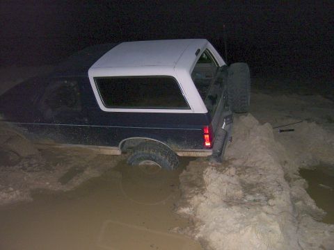 1992 Ford Bronco - This 1992 Ford Bronco is stuck in a muddy area at night.