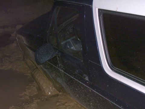 1992 Ford Bronco - This 1992 Ford Bronco is stuck deep in the mud, with its front tire almost completely covered.
