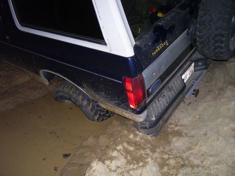 1992 Ford Bronco - This 1992 Ford Bronco is stuck in the mud, with its rear tire submerged.