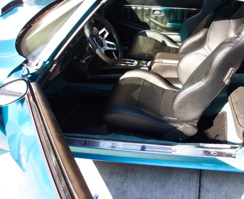 1979 Pontiac Trans Am - The interior of a car is shown with a focus on the front seats and dashboard details.