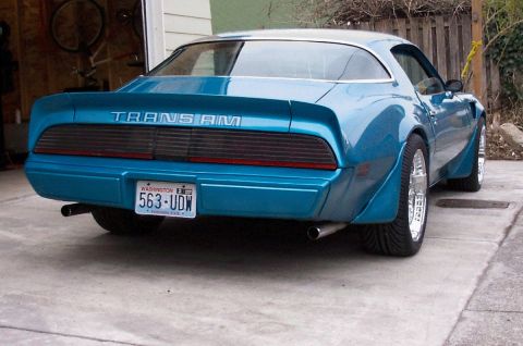 1979 Pontiac Trans Am - The rear of a blue 1979 Pontiac Trans Am is shown, with a Washington state license plate.