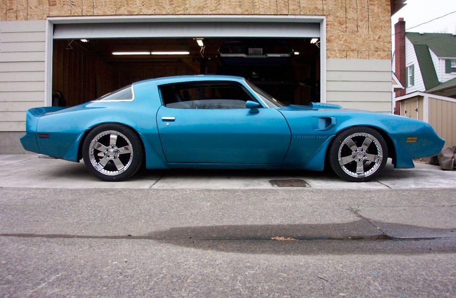 Blue 1979 Pontiac Trans Am parked in front of an open garage