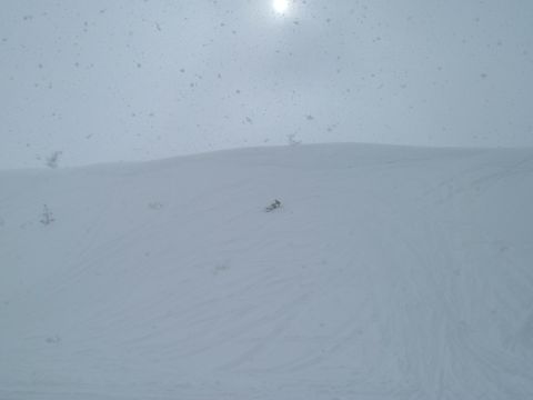 1997 Arctic Cat Powder Special EFI - A snowmobile is seen on a snowy slope under a bright sun.
