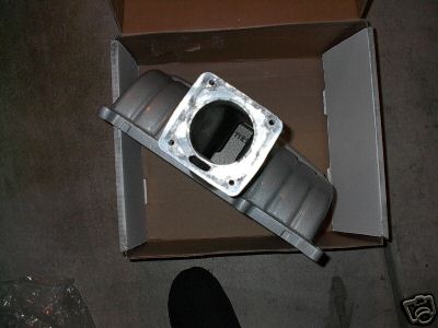1991 Ford Bronco - An aluminum intake manifold is shown inside a cardboard box, with its mounting flange visible.
