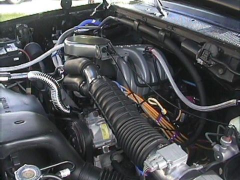 1994 Ford Bronco - The engine bay of a 1992 Ford Bronco, with a focus on the air intake system and associated components.