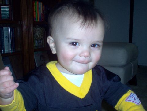 2004 Ford F-150 - A baby smiles at the camera, with a bookshelf and furniture visible behind them.