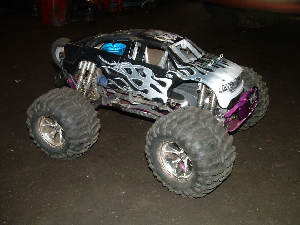 Remote control monster truck with flame decals and purple bumper