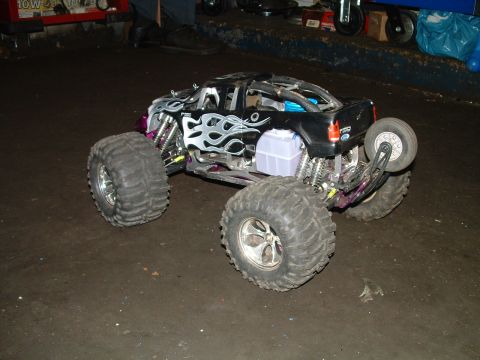 1994 Ford Bronco - This remote-controlled truck features a black body with silver flame graphics and oversized off-road tires.