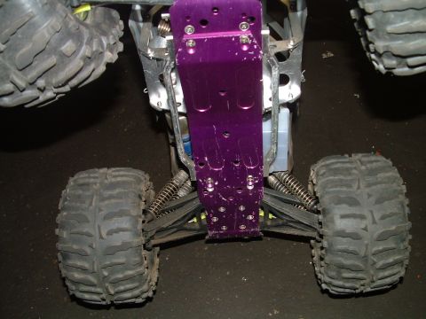 1994 Ford Bronco - Close-up view of the chassis and suspension of a remote control monster truck, large off-road tires.