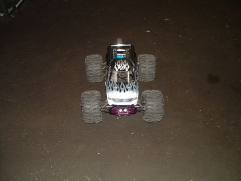 1994 Ford Bronco - This remote control monster truck has flame decals and a purple front bumper.