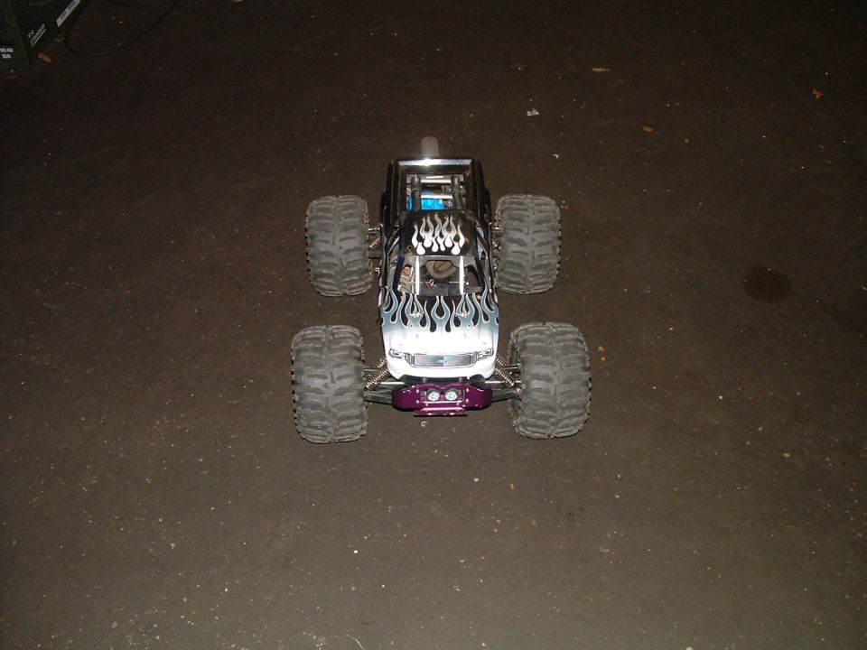 Remote control monster truck with flame decals and purple bumper