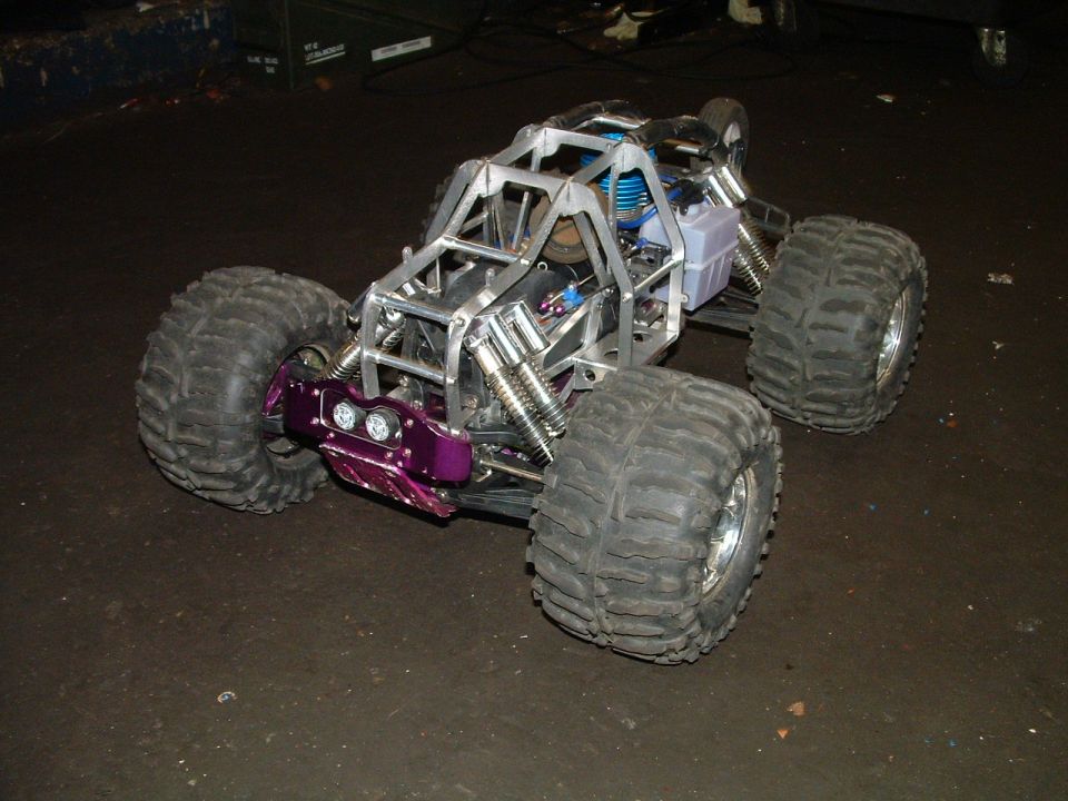 Purple front bumper on custom RC car with exposed engine and large tires