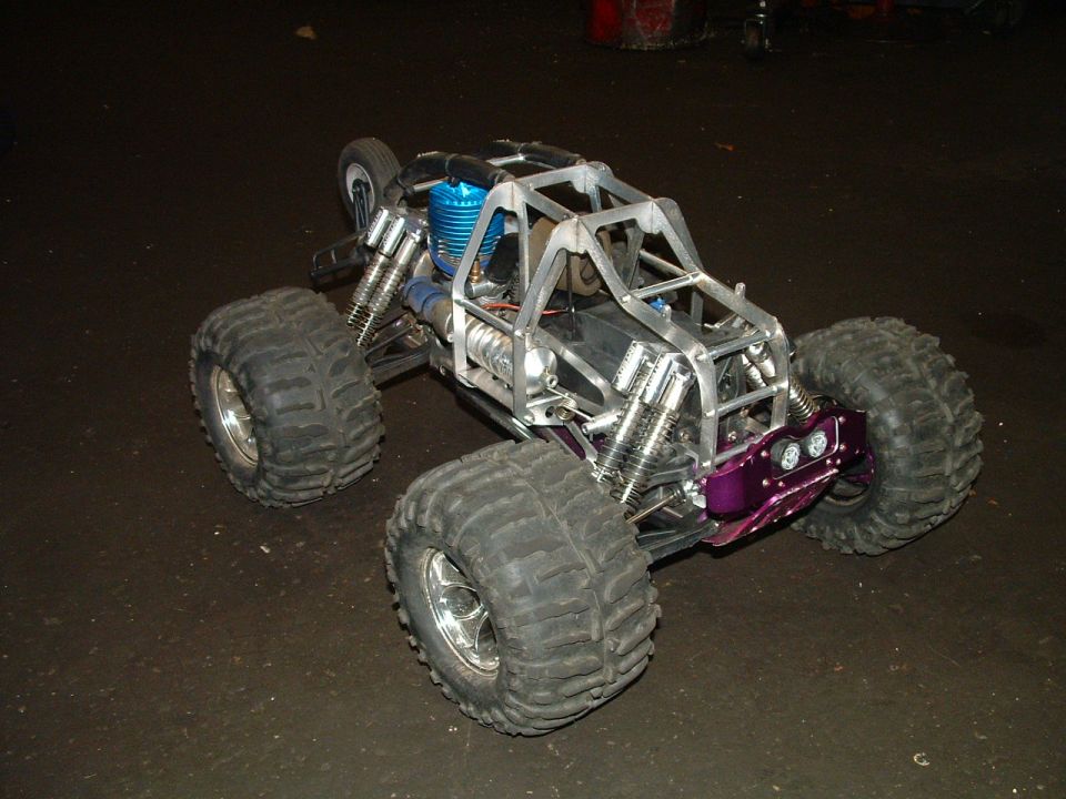RC monster truck with a metal frame, large tires, and a purple front bumper