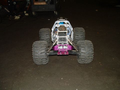 1994 Ford Bronco - This remote control monster truck features oversized tires and a distinctive purple front bumper, suggesting a custom build.