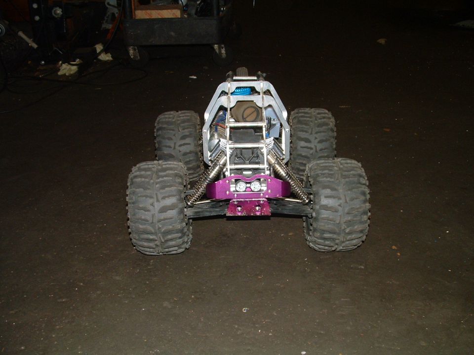 Remote control monster truck with large tires and purple front bumper
