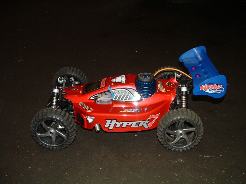 Red remote control buggy with blue wing and "Hyper 7" graphics