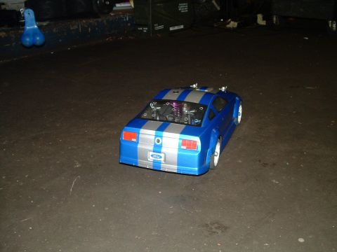 1994 Ford Bronco - Remote-controlled car with racing stripes and visible engine parts.