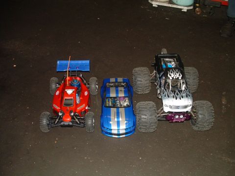 1994 Ford Bronco - A collection of three remote control vehicles, including a buggy, a coupe, and a monster truck, are displayed side-by-side.