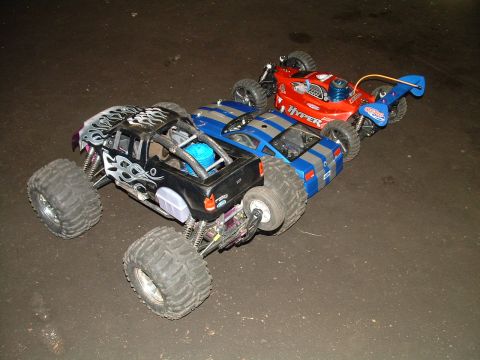 1994 Ford Bronco - Collection of remote control vehicles including a monster truck and two cars.