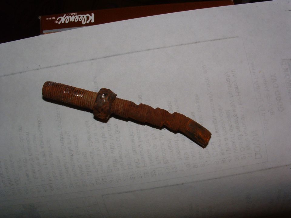 Rusty metal part with threaded end and serrated section
