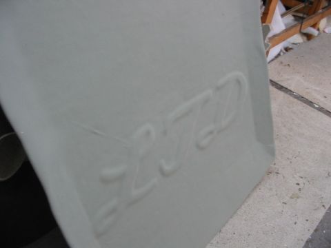 1985 Ford Crown Victoria LTD - Embossed text is visible on a light gray panel, possibly a car part.