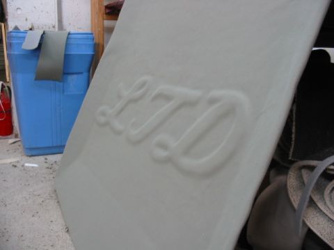 1985 Ford Crown Victoria LTD - Close-up of an embossed LTD emblem on a vehicle interior component.