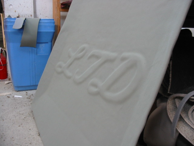 Embossed LTD lettering on a light-colored car interior panel