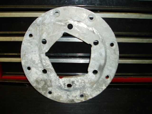 round metal flange with a square cutout and 12 bolt holes