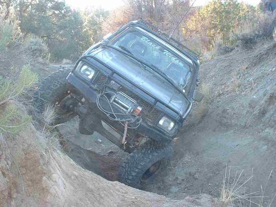 Black SUV with "Black Widow" on windshield navigating steep terrain